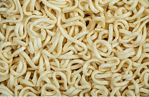 Spaghetti noodles tangled up; analogous to the manner in which long-chain molecules entangle.