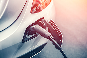 Photo of car filling up with gas at a gas station.