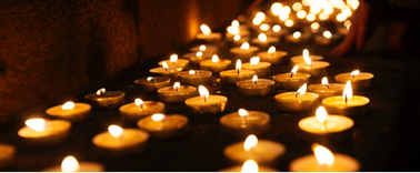 Photo of several candles burning as an example of a spontaneous process.