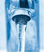 Liquid water pouring from a faucet.