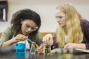 Two students in lab conducting an investigation.