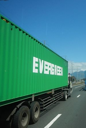 Photo of a semi-truck driving down the highway